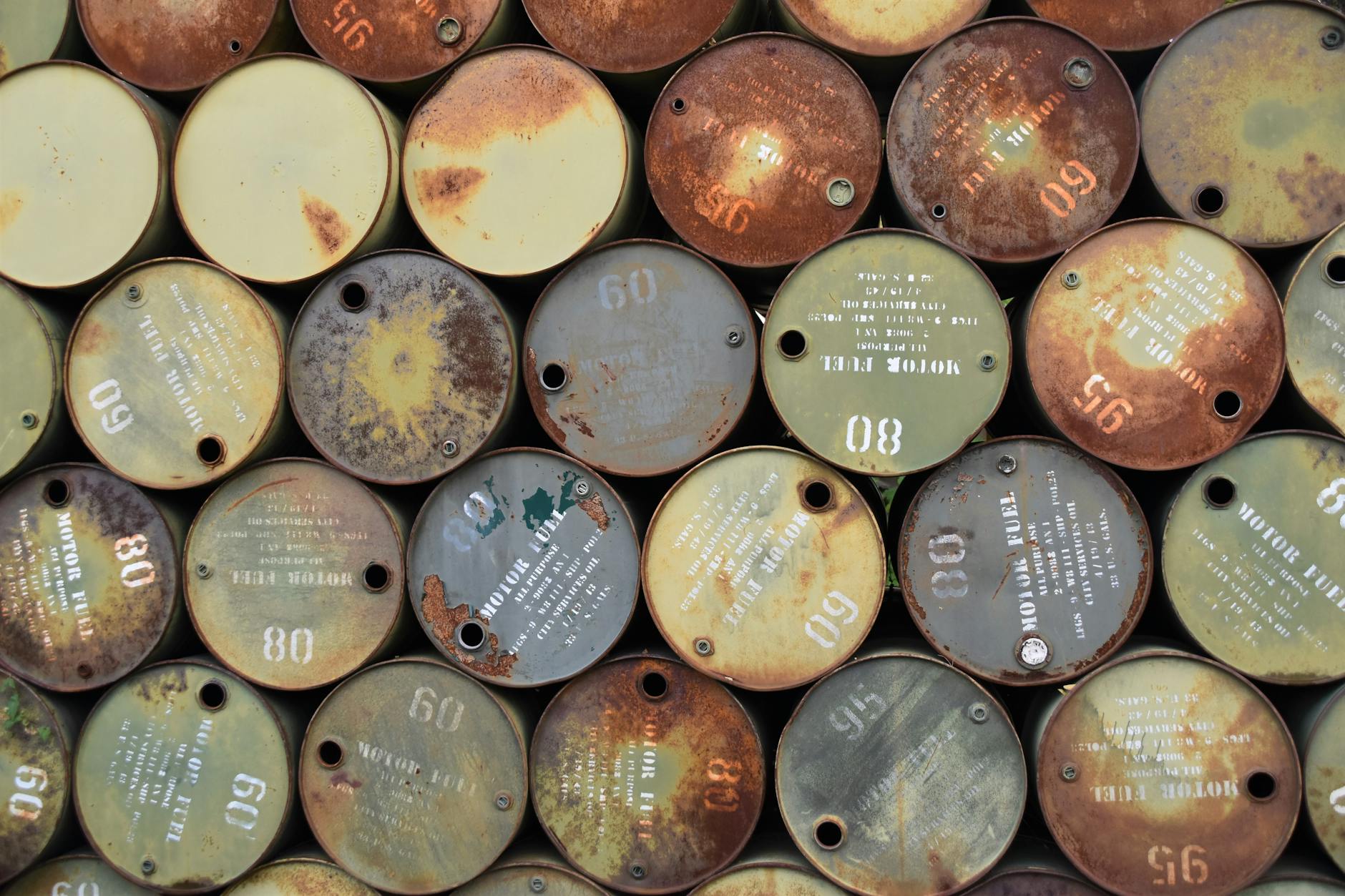 Large petroleum storage facility with multiple oil barrels and tanks