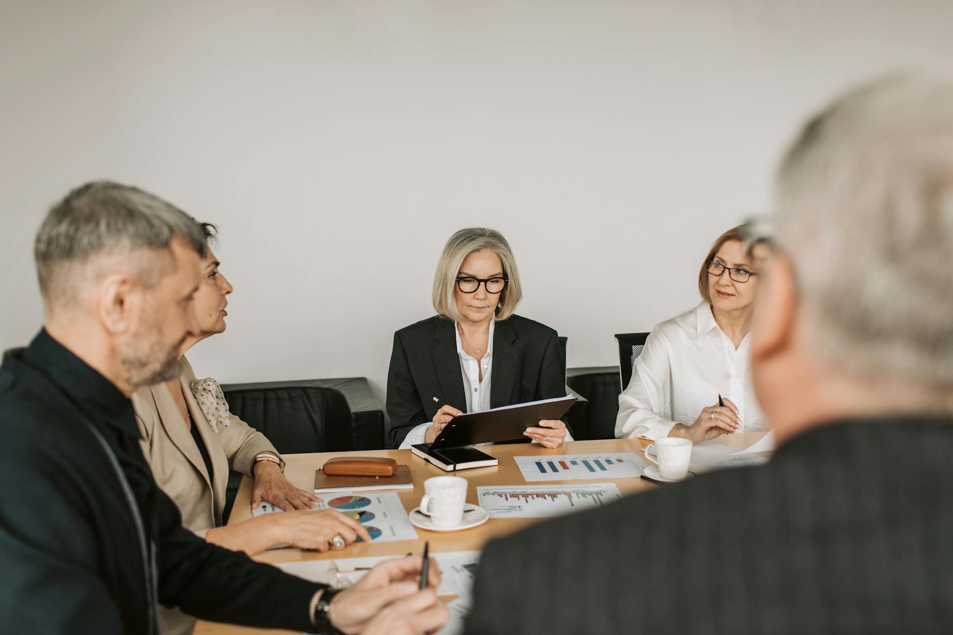 Business executives analyzing technology strategy charts