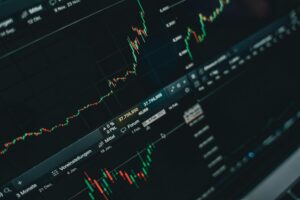 Financial data and stock market charts displayed on computer screens