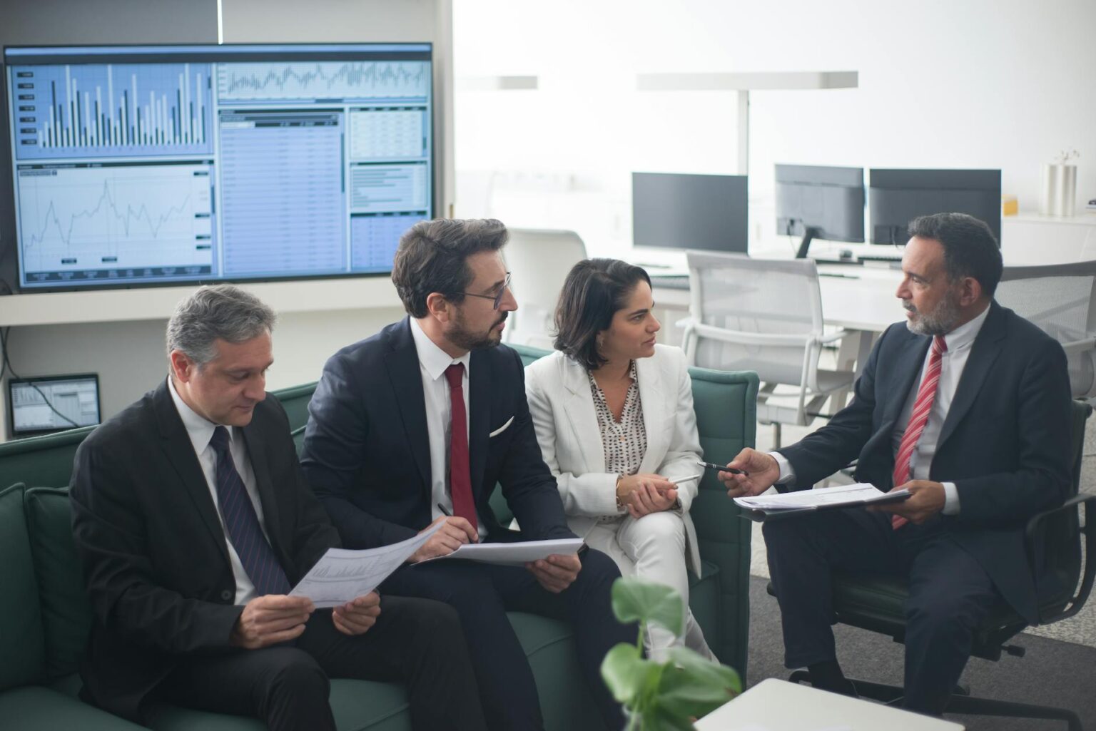 Business professionals reviewing financial documents and charts