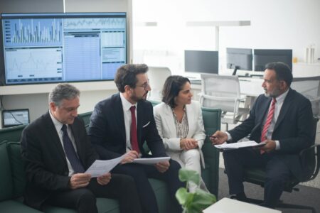 Business professionals reviewing financial documents and charts