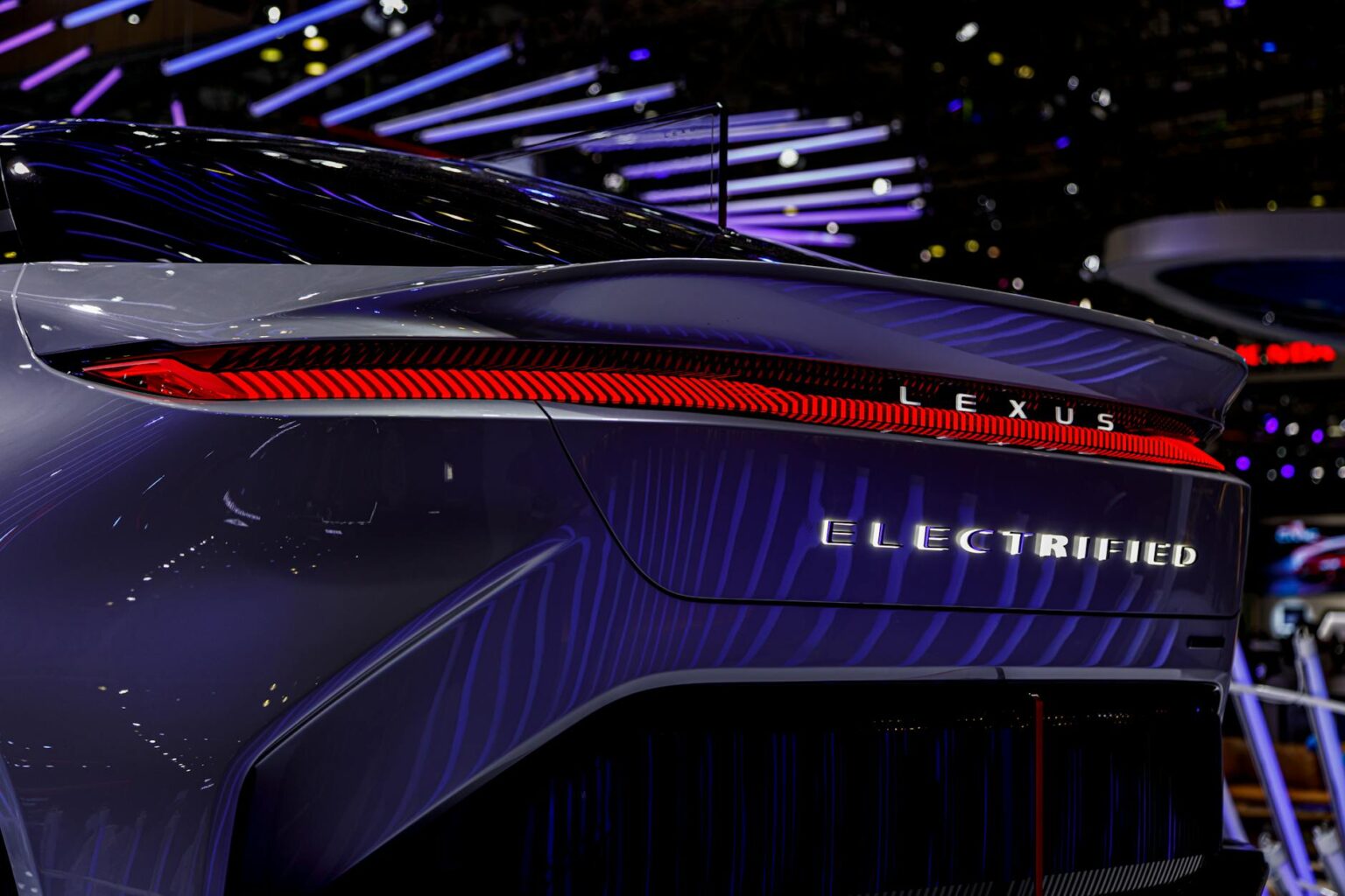 A sleek electric luxury performance car on an empty road