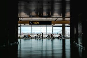Travelers walking through a busy airport terminal during peak travel season