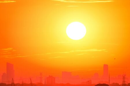 UN Puts 75% Odds on Breaching the 1.5-Degree Climate Threshold Hazy urban skyline under intense heat with distorted air visible above streets