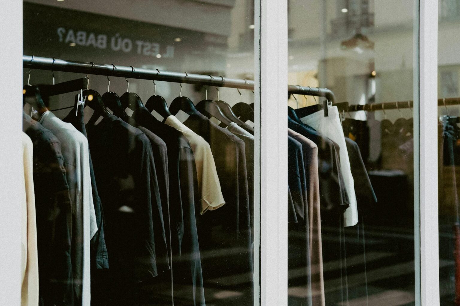 Interior of a clothing retail store with apparel displayed on racks