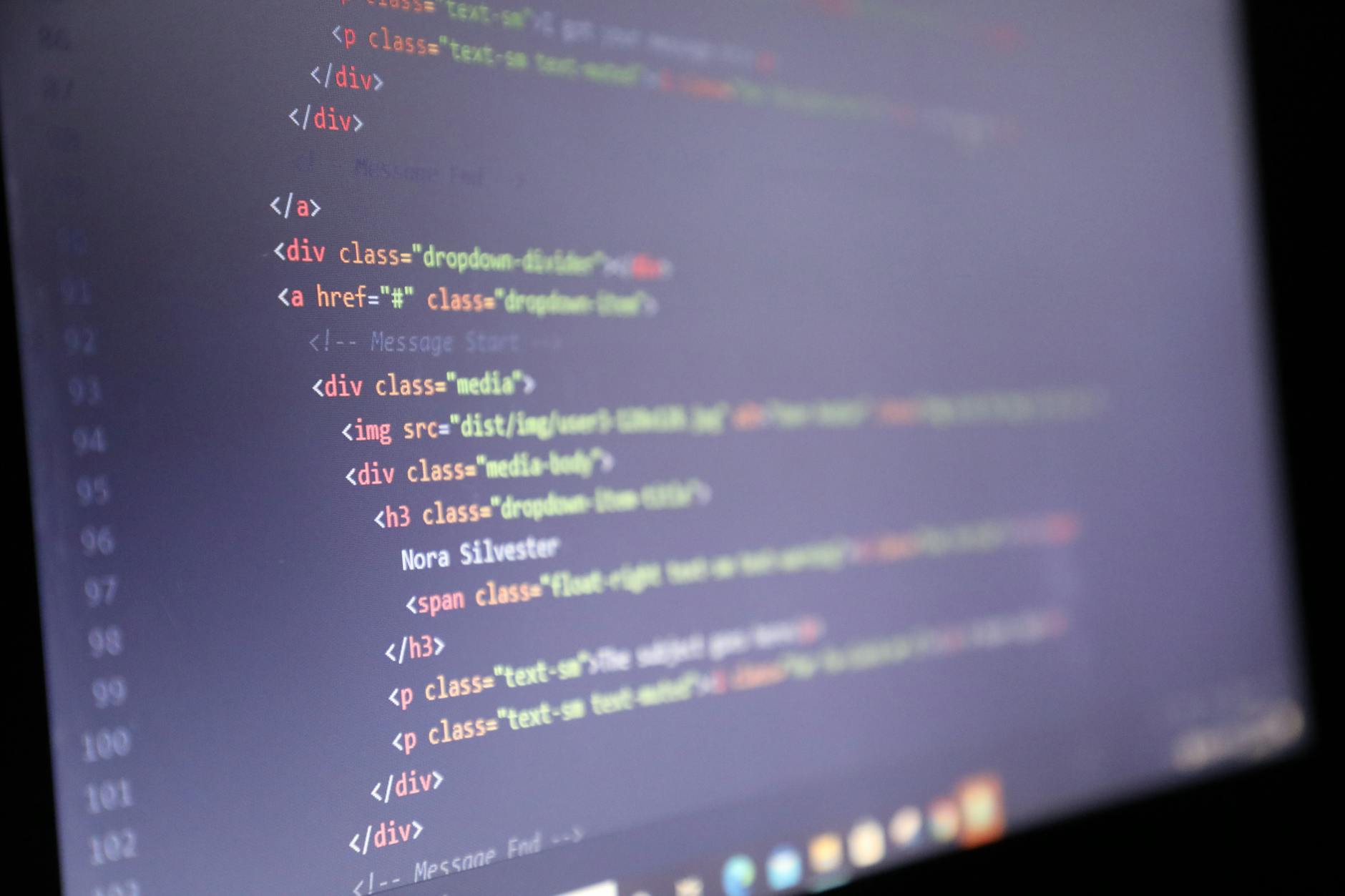 Close-up view of computer screen displaying code and programming interface