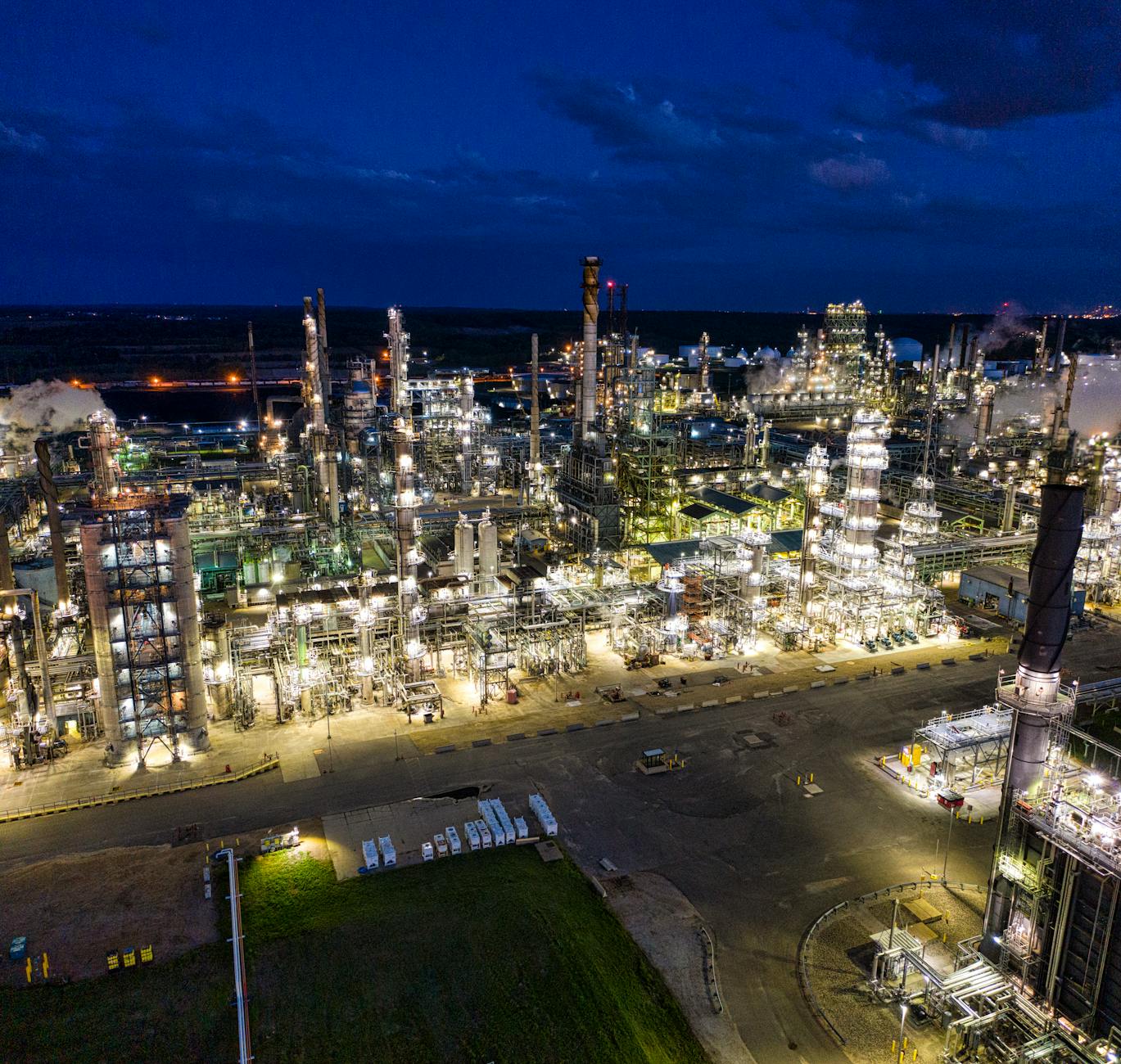 Industrial oil refinery facility illuminated at night