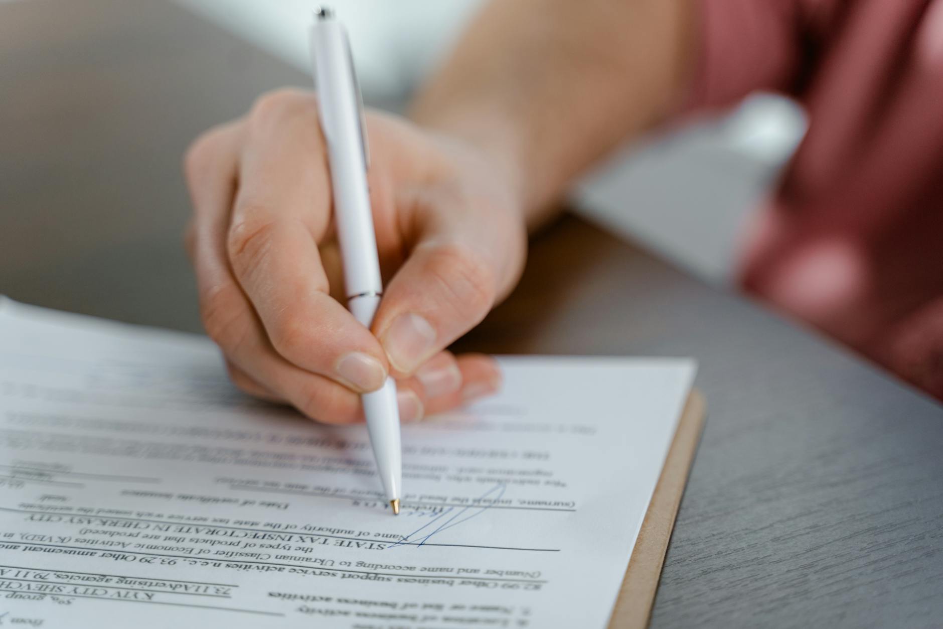 Business contract being reviewed and signed at desk