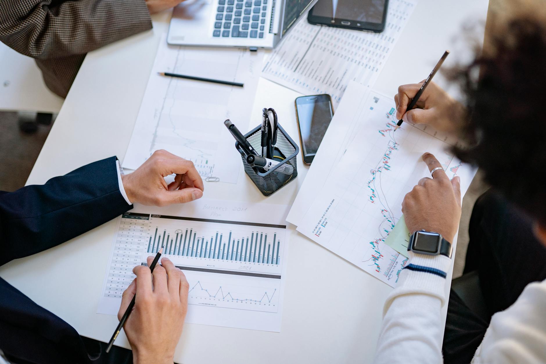 Business professionals reviewing charts and data in a corporate meeting