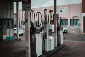 Driver pumping gas at a fuel station as prices rise