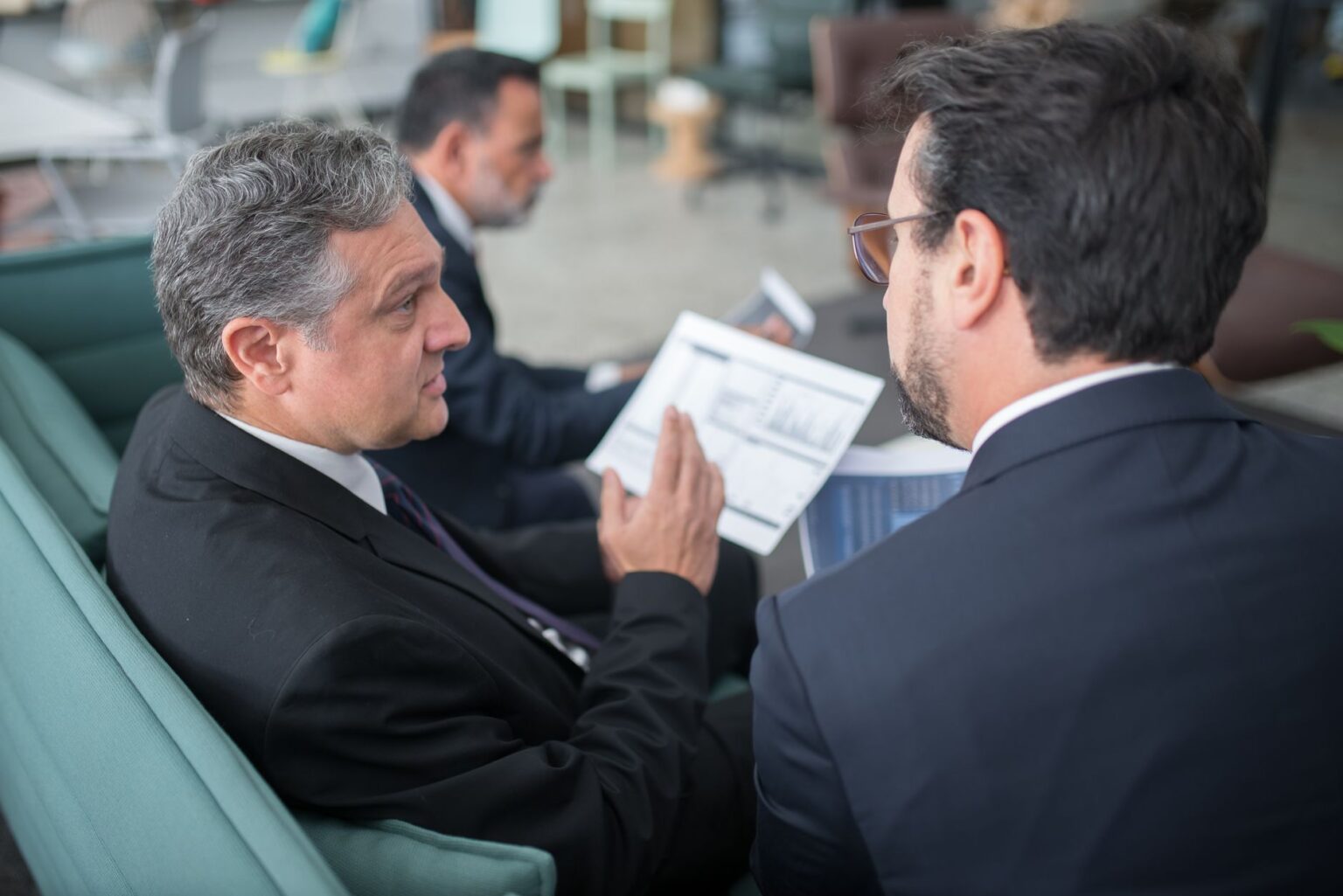 Consultants working at a large corporate office reviewing business strategy documents