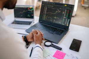 Trader watching stock market screens showing mixed futures activity