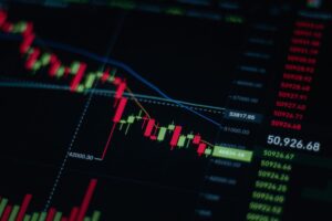 Stock market futures display showing declining Nasdaq and S&P 500 numbers on a trading screen