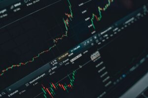 Trader watching mixed stock market futures on multiple screens