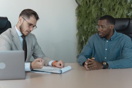 A recruiter interviewing a job candidate in a modern office setting