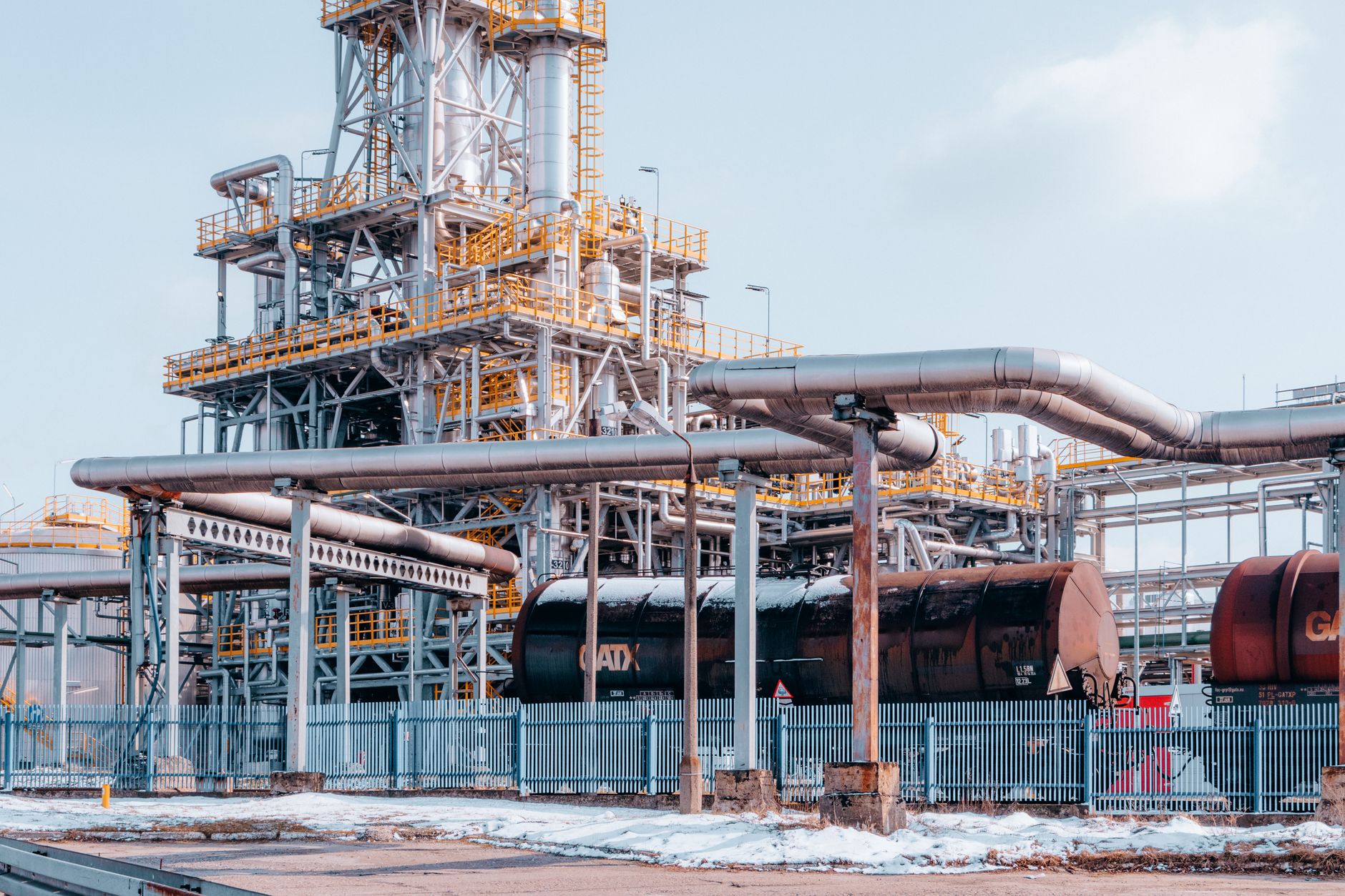 Oil storage barrels and pipeline infrastructure representing crude supply