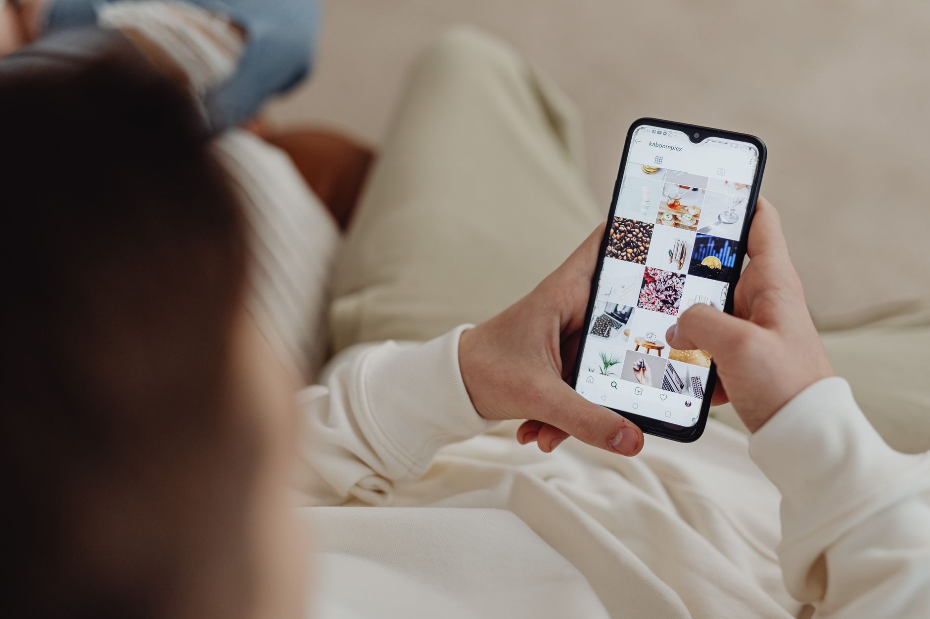 Person scrolling through social media feed on a smartphone