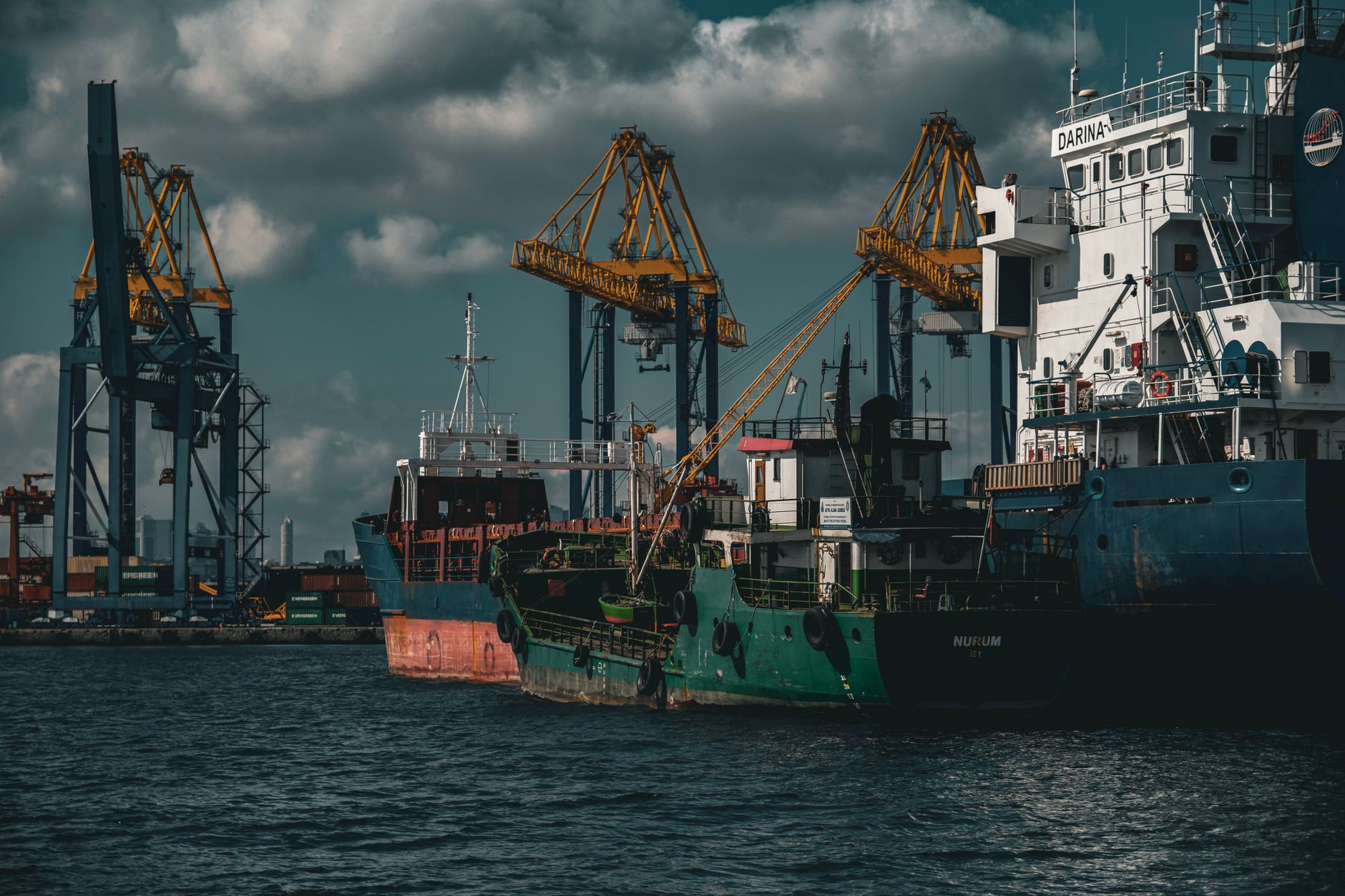Commercial cargo ship navigating a busy shipping port