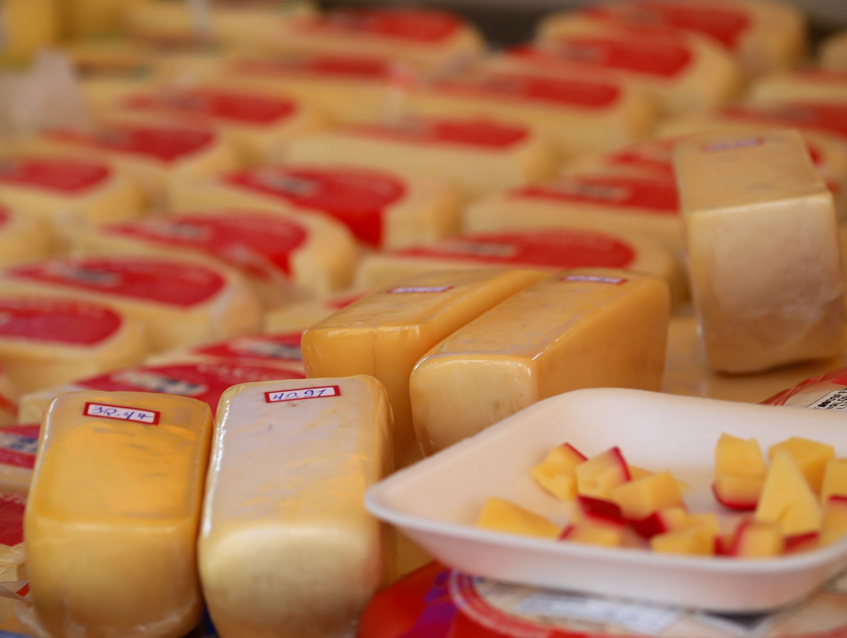 Dairy products and cheese wheels on display representing U.S.-Canada dairy trade dispute