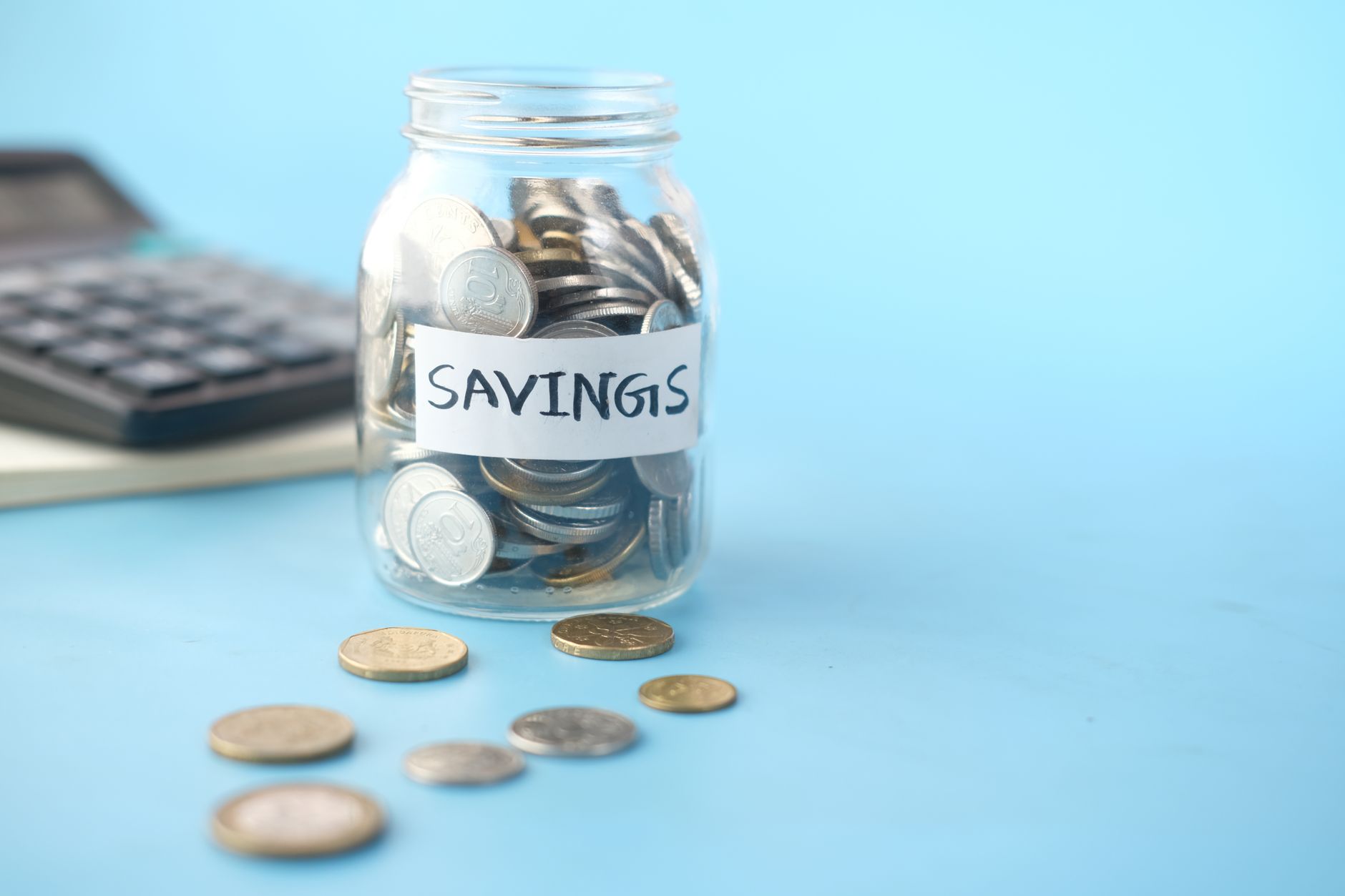 Person reviewing financial savings plan with documents and calculator