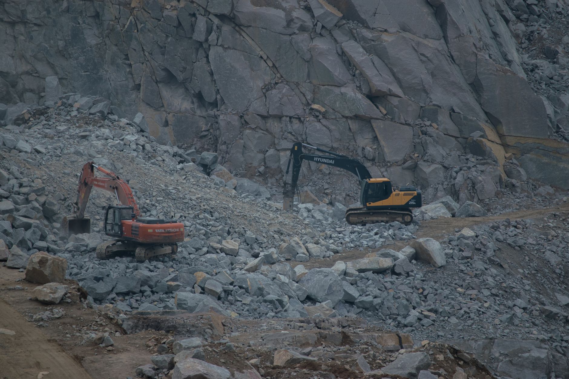 Open pit silver mine with heavy excavation equipment operating at depth
