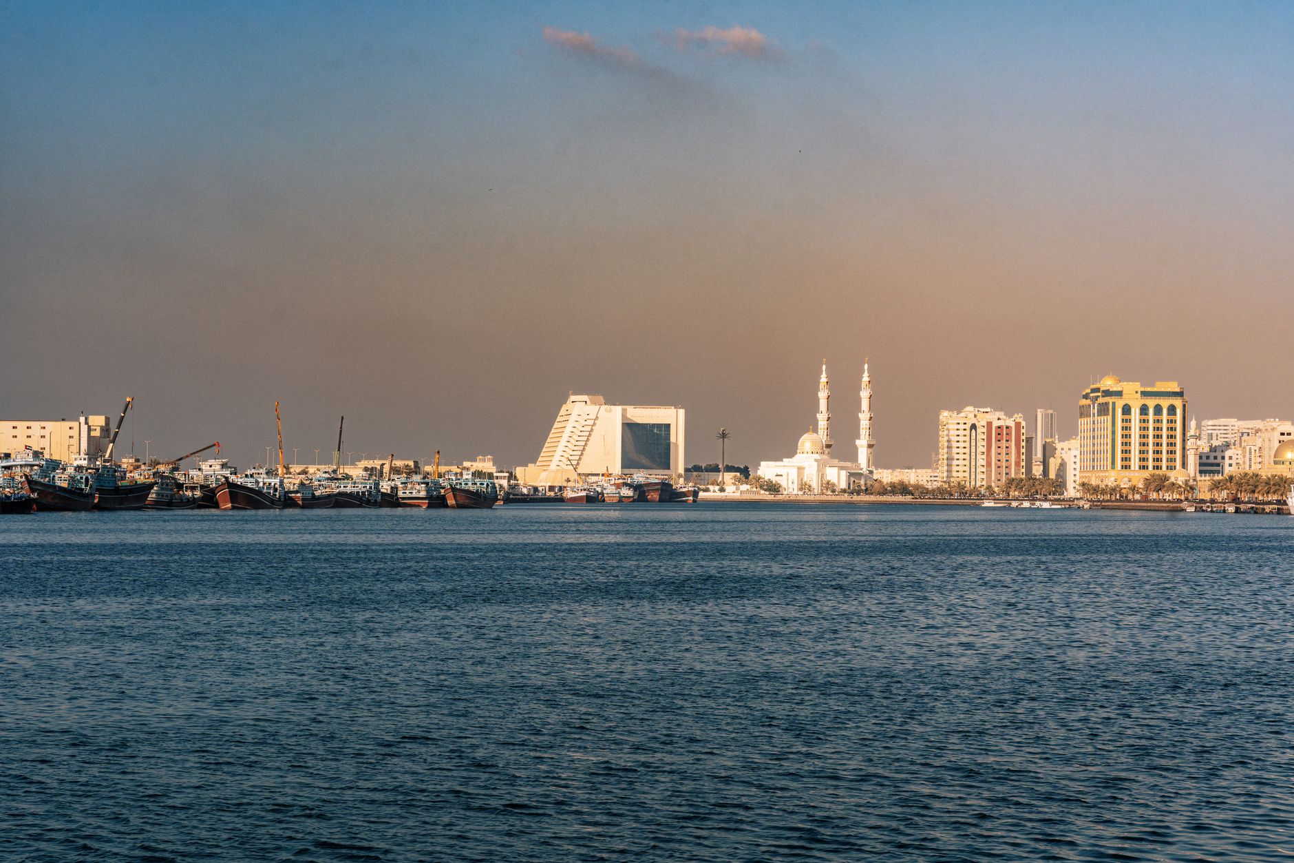 Modern Gulf city skyline with financial district buildings at dusk