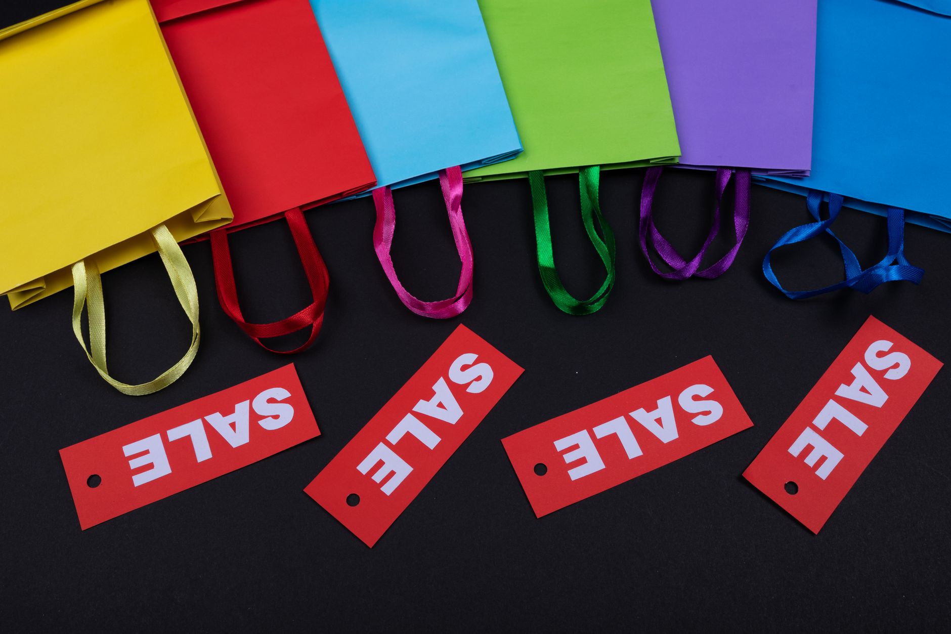 Close-up of sale price tags on garments in a fashion retail environment