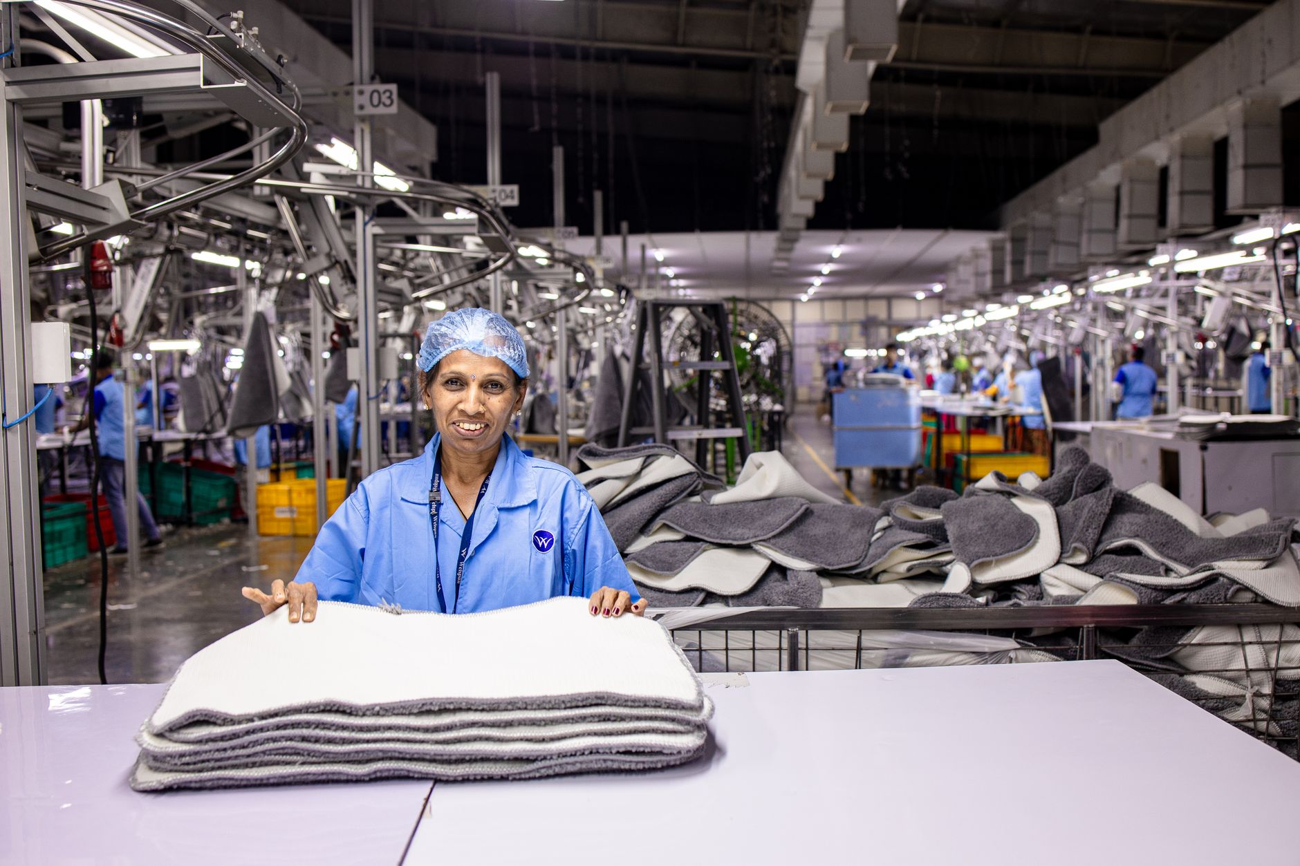 Workers on an automotive assembly line representing cross-border auto manufacturing