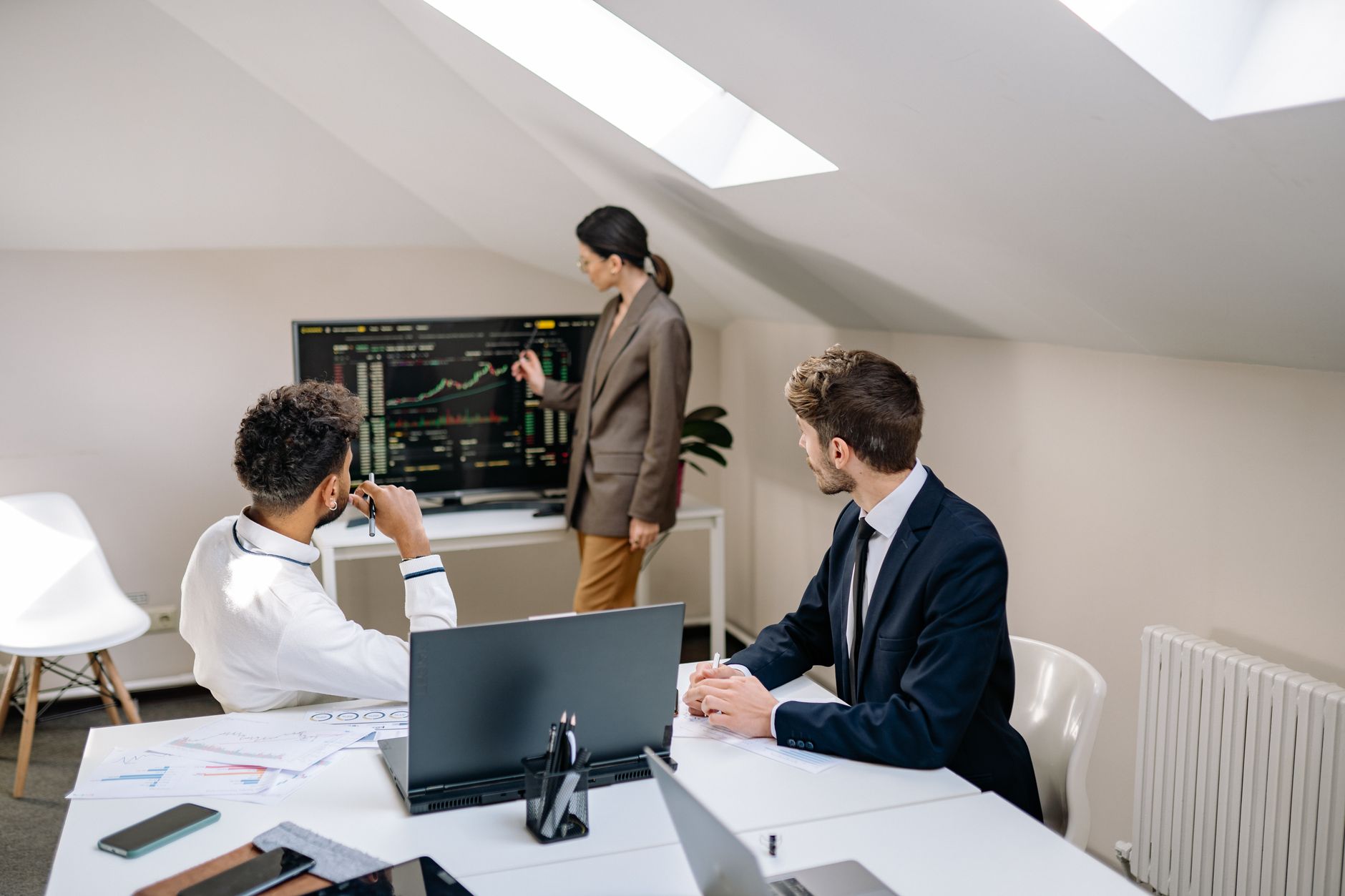Two professionals reviewing investment documents at a conference table