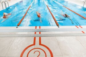 Empty competitive swimming pool with lane dividers viewed from above
