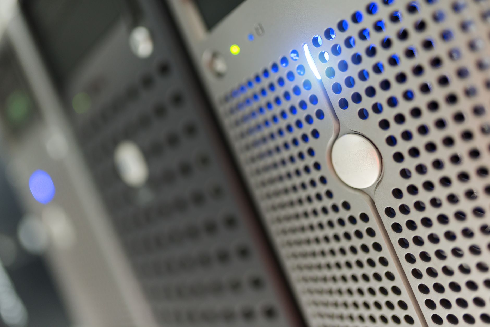 Rows of illuminated servers inside a large data center facility