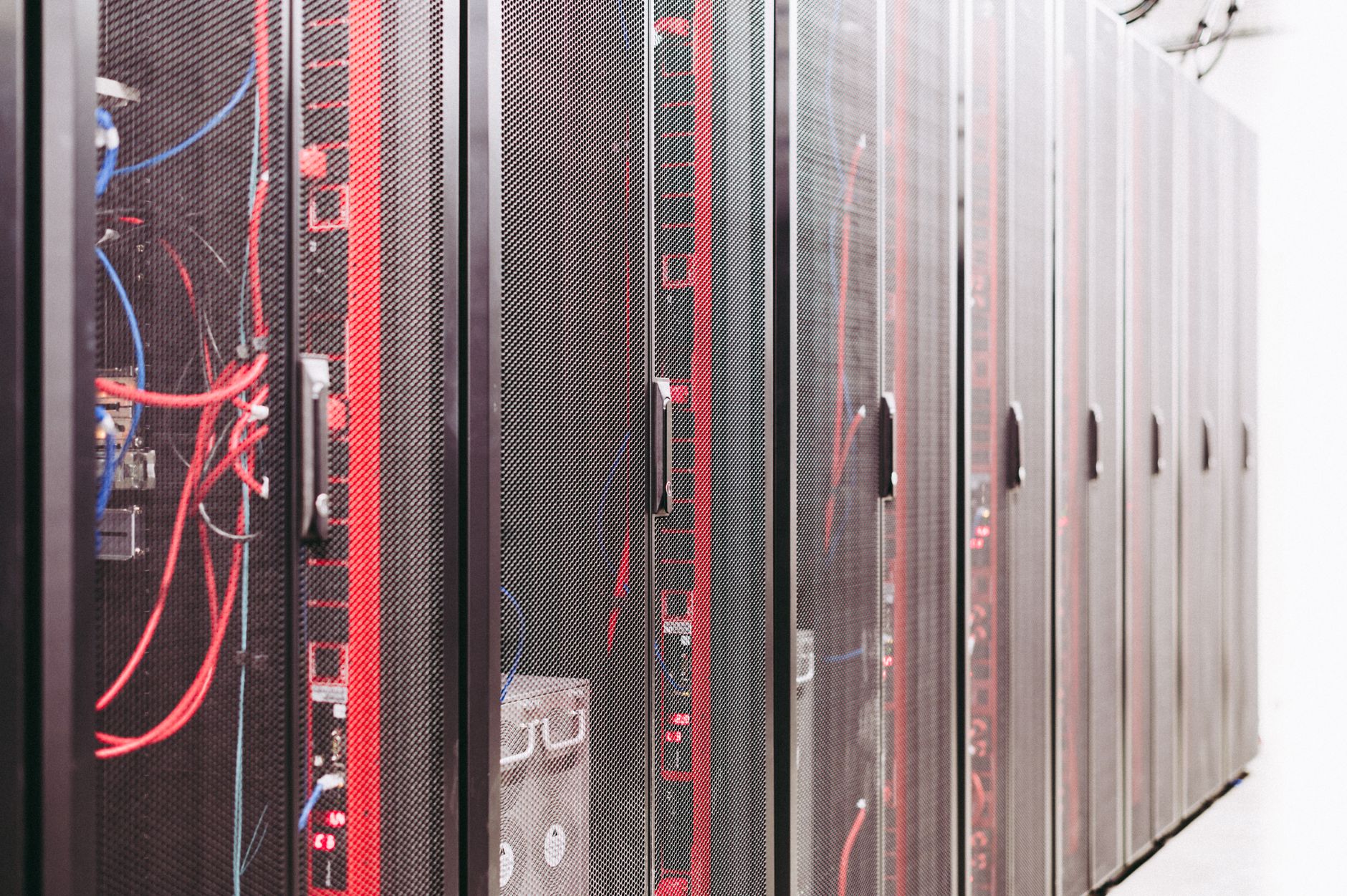 Rows of servers inside a large AI data center facility