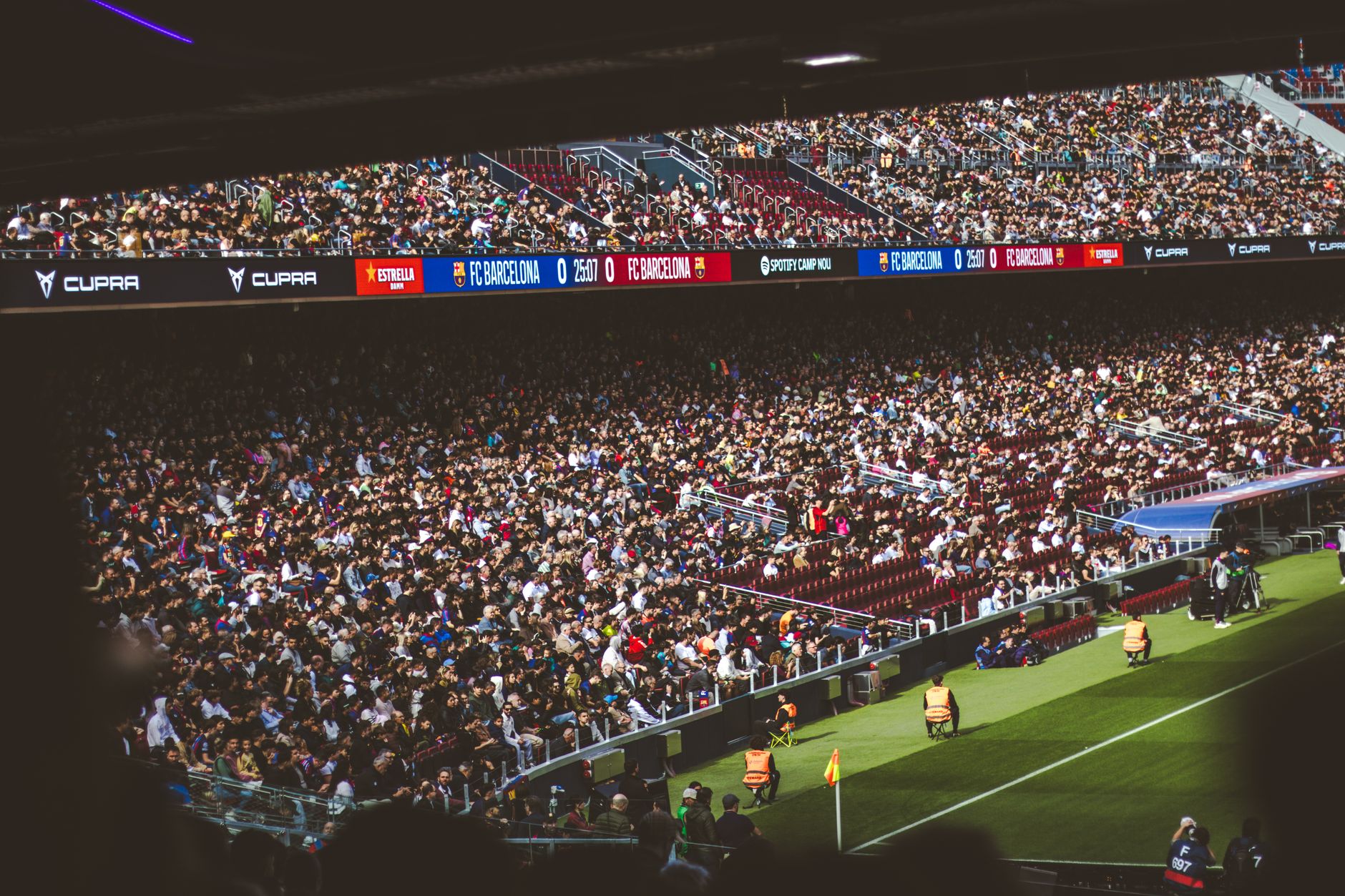 Packed NFL stadium with fans cheering during a night game