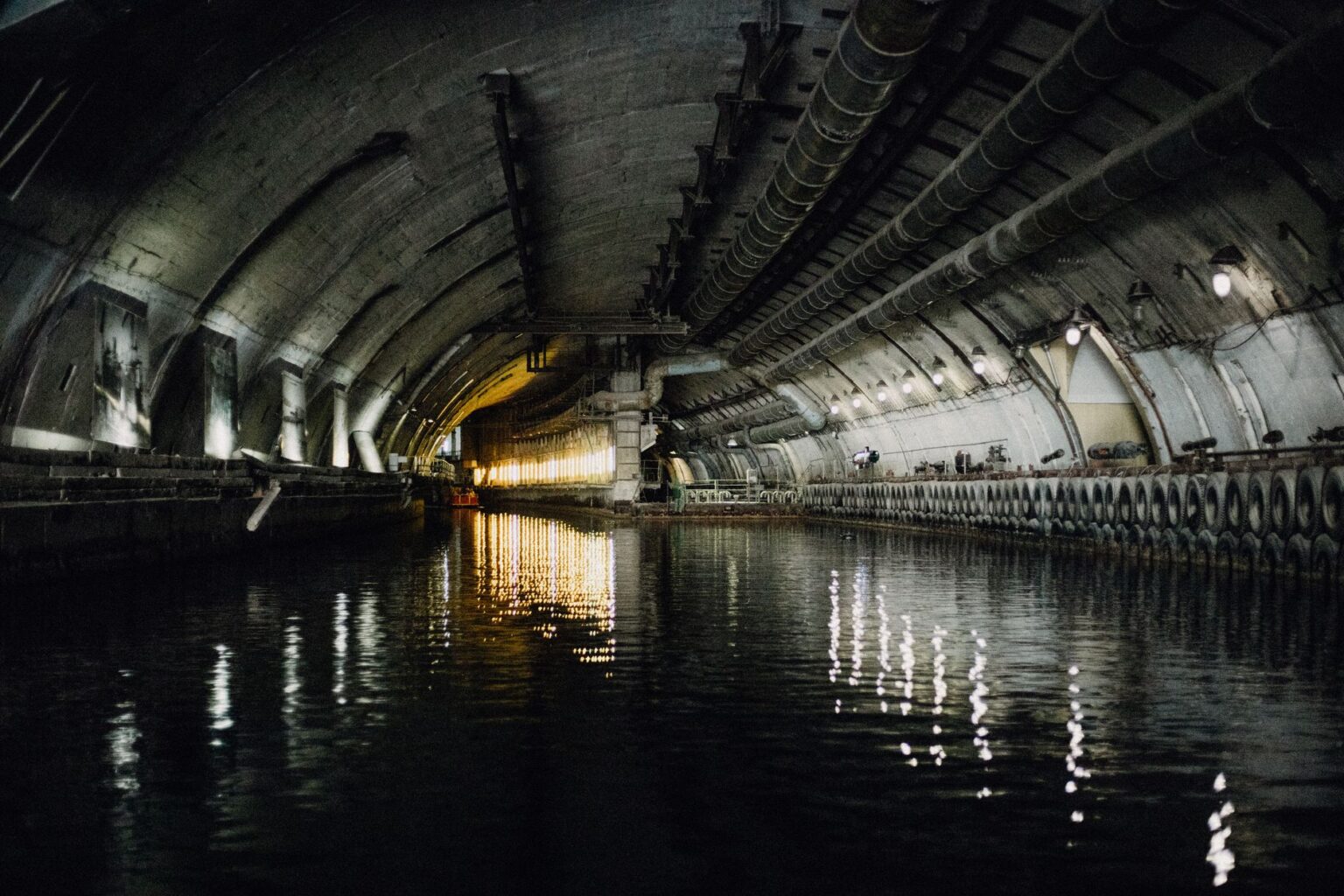 Workers inside a large underground tunnel during construction