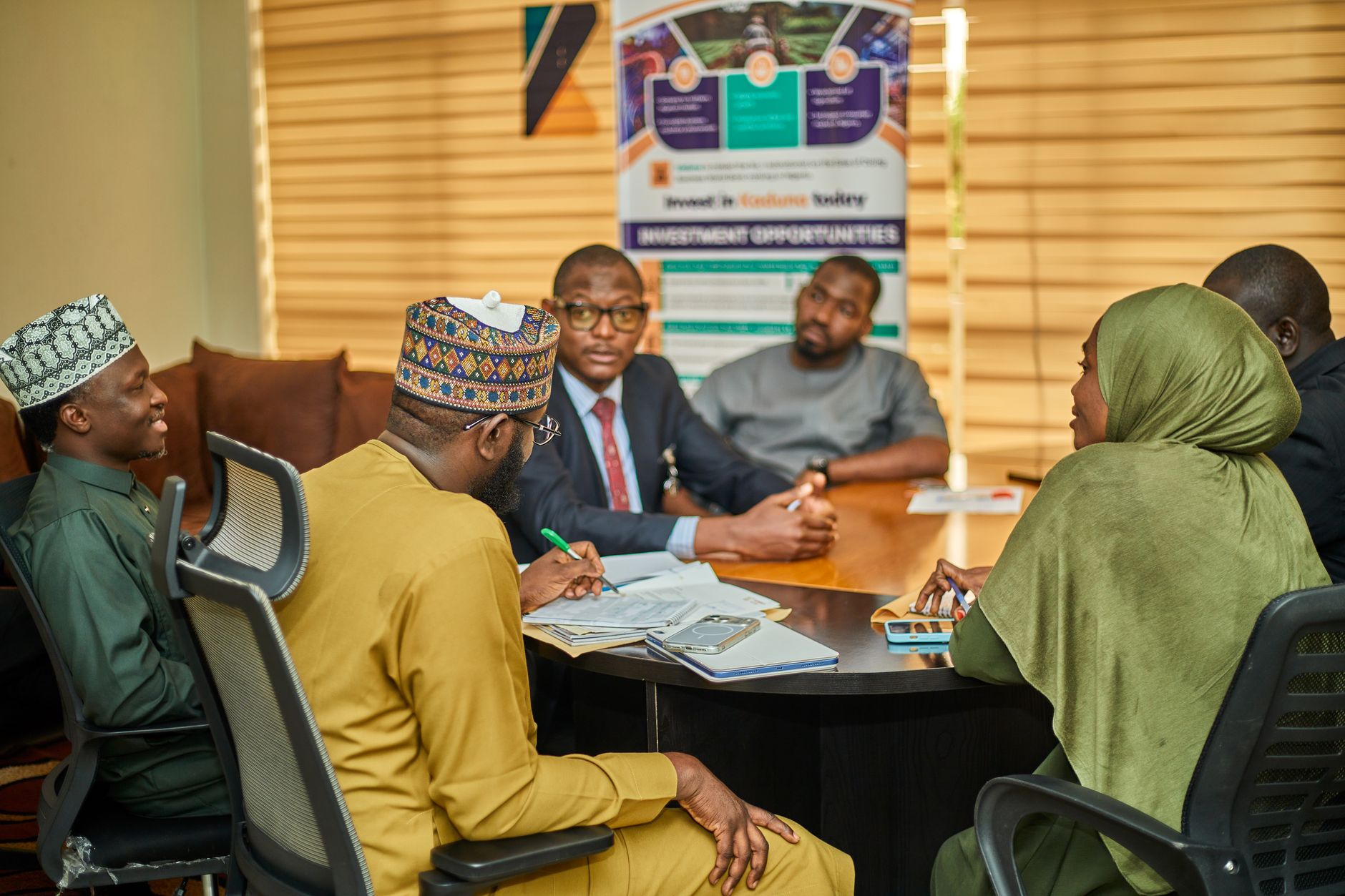 Business professionals reviewing documents at a private investment meeting
