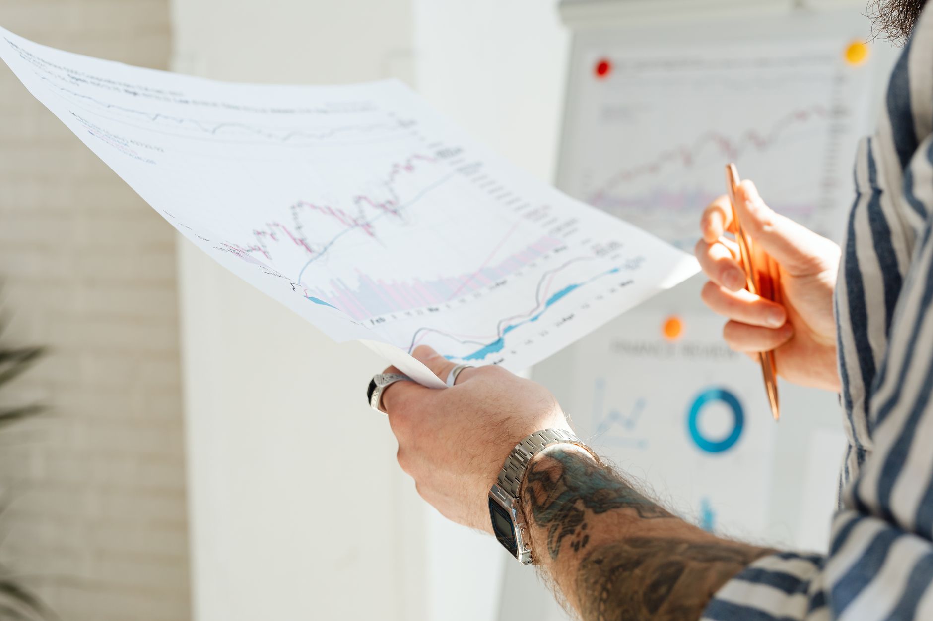 Analyst reviewing financial charts and earnings data on a screen