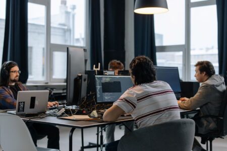 Software developer working at a computer in a modern office setting