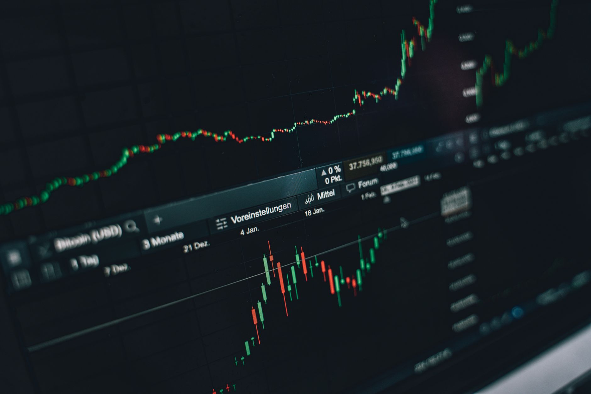 Economist reviewing inflation data and financial charts on a monitor